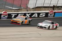 Noah Gragson (9) and Harrison Burton (20) come out of turn four onto the front stretch during a ...