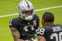 Las Vegas Raiders wide receiver Henry Ruggs III (11, left) greets teammate Las Vegas Raiders ru ...