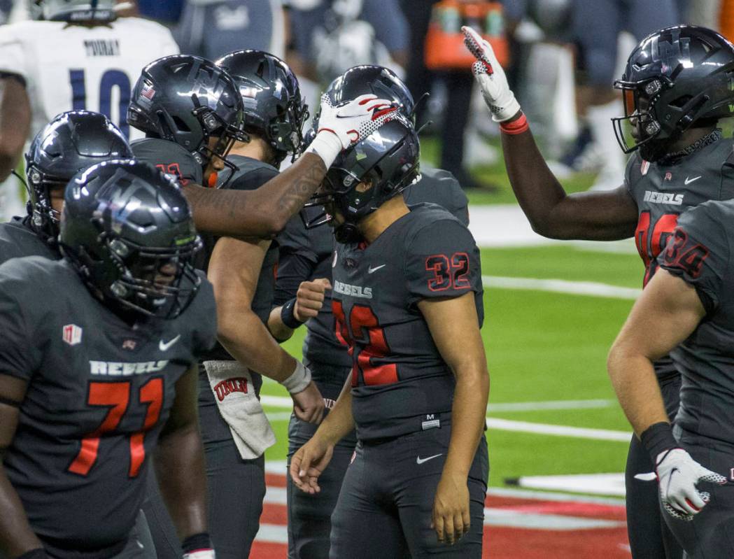 UNLV Rebels kicker Daniel Gutierrez (32, center) is congratulated on another field goal by team ...
