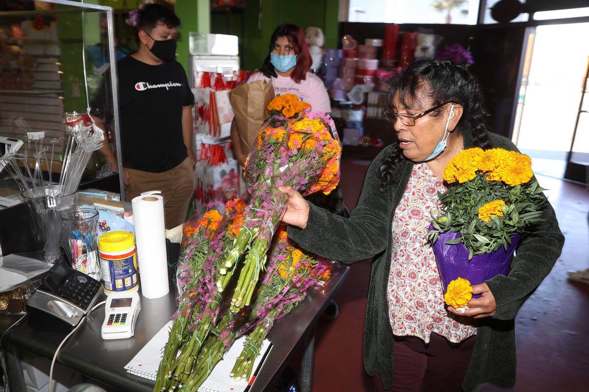Isabel Cuautle, right, with her grandchildren Jonathan Ascue, left, and Emili Moran, buys Mexic ...