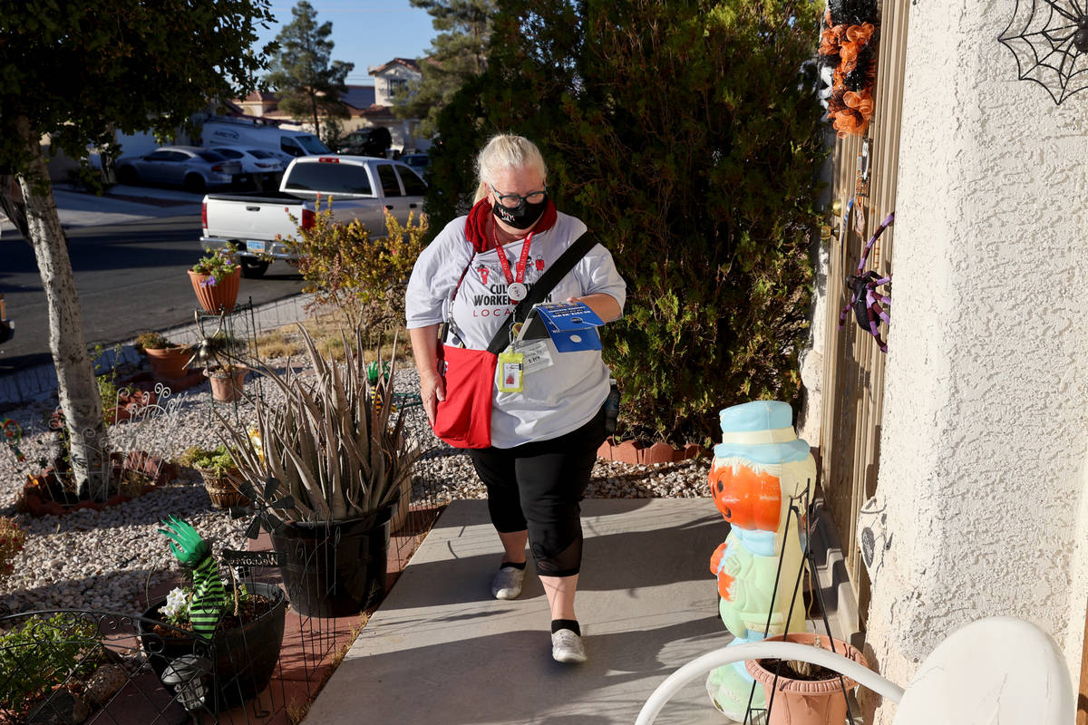 Culinary Union member Donna Kelly-Yu canvasses in North Las Vegas Friday, Oct. 30, 2020. (K.M. ...