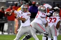 Ohio State quarterback Justin Fields (1) looks for a receiver during the first quarter against ...
