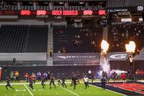 UNLV Rebels players take the field to face the Nevada Wolf Pack game before the first half of t ...