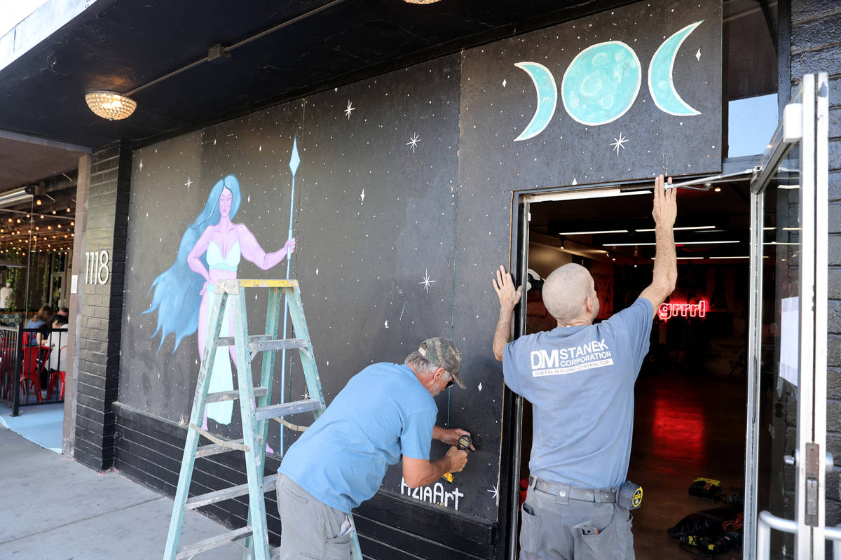 John Coker, left, and Daniel Haner board up windows in preparation for Election Day at Grrrl at ...