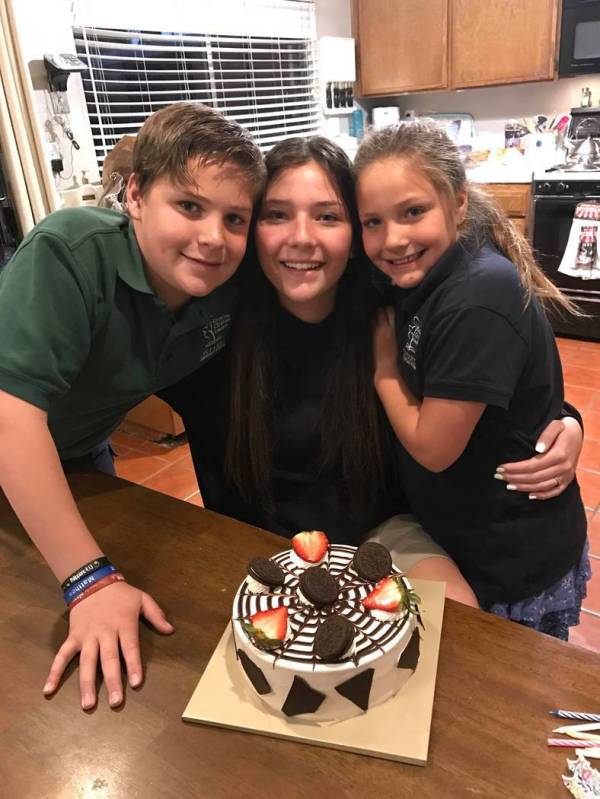 Micaela Miller, 15, center, Noah Miller,11, left, and Madison Miller, 8, made a cake for their ...
