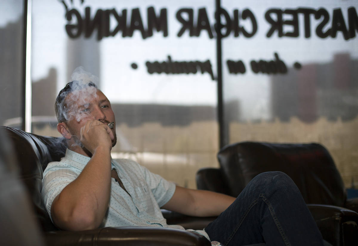 Comedian Rocky Dale Davis smokes a cigar at his regular hangout, En Fuego Cigars & Lounge in La ...