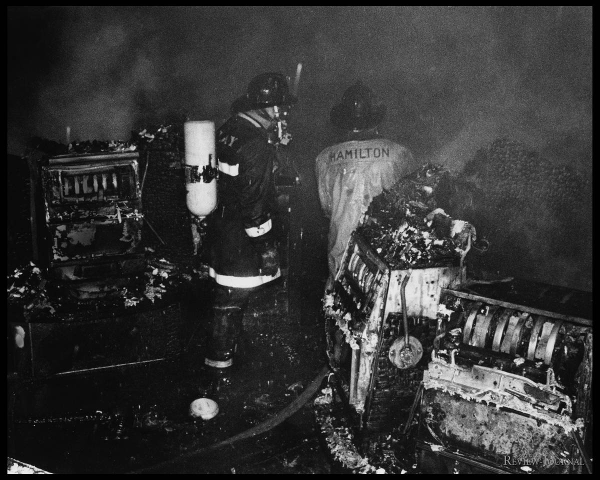 In this Nov. 21, 1980, file photo, Clark County firefighters survey the damage on the casino fl ...