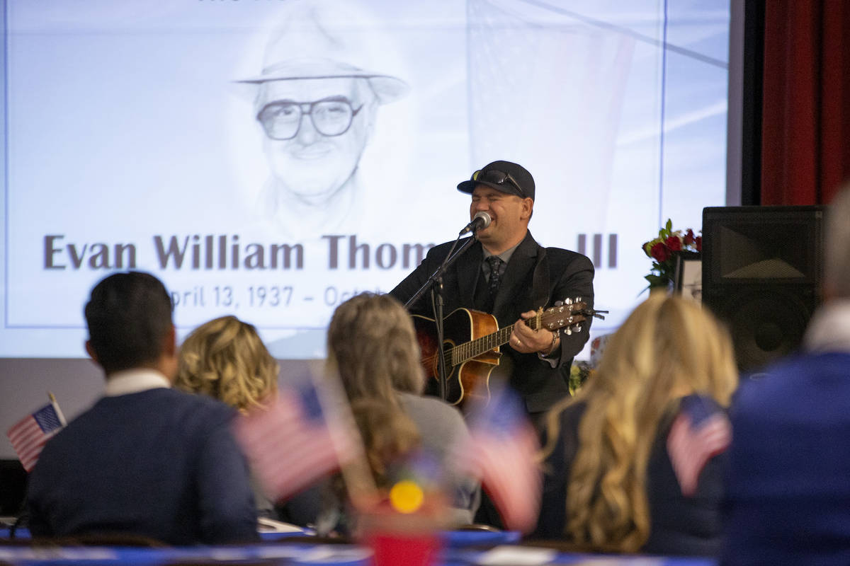 Elan Thompson, son of Navy veteran Evan Thompson III, sings a country song during his father's ...