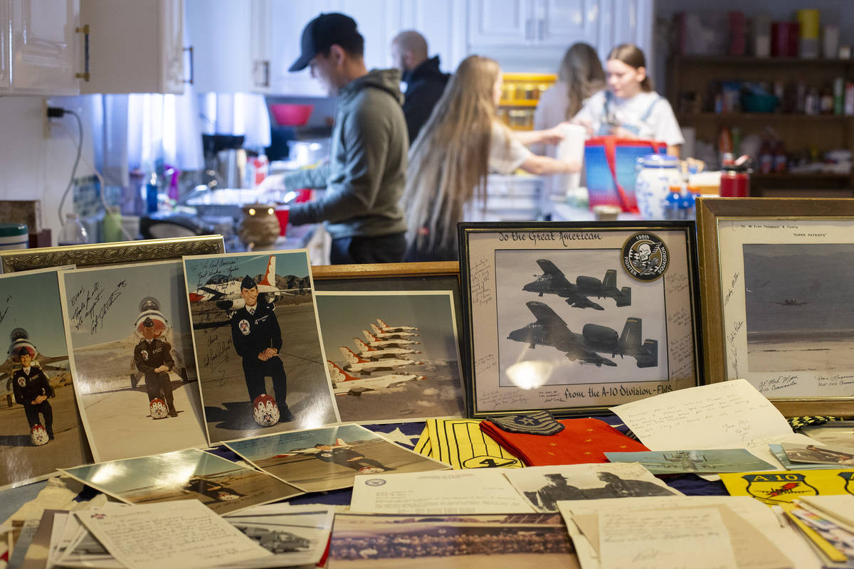 Photos and trinkets honor Navy veteran Evan Thompson III as his family and friends gather for a ...