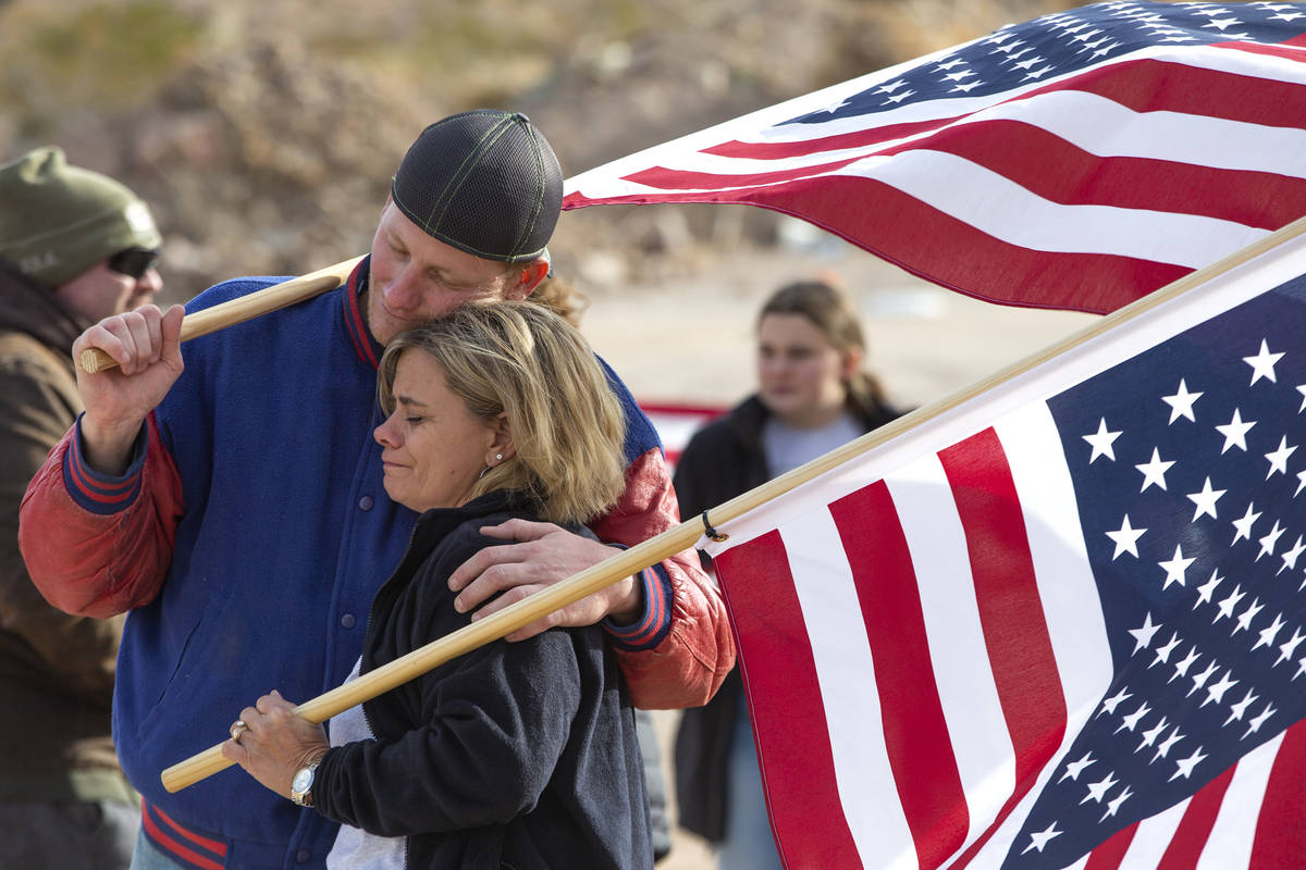 Oliver Thompson hugs his sister Heather Ball after Airforce fighter pilots flew over them in me ...
