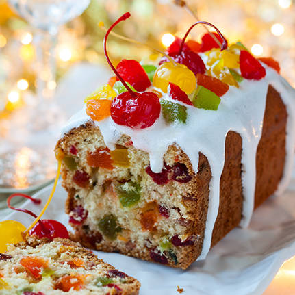 Christmas fruitcake with sugar icing and candied fruits