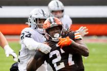 Las Vegas Raiders strong safety Johnathan Abram (24) tackles Cleveland Browns running back Kare ...