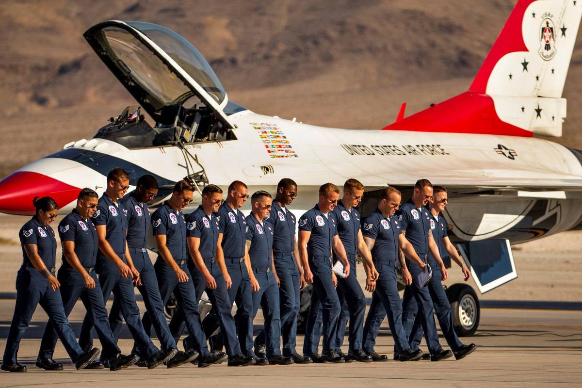 The ground crew with the U.S. Air Force Thunderbirds check for foreign objects on the tarmac be ...