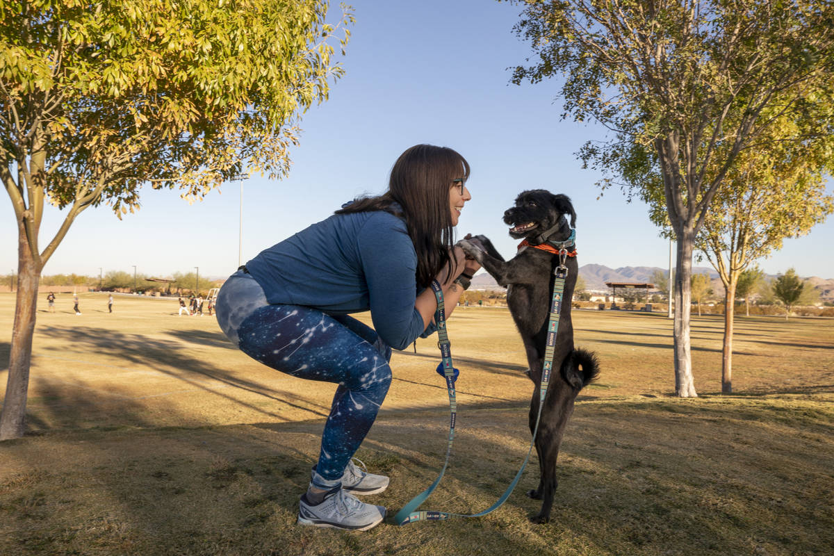 Rachel DiNola, a registered nurse and volunteer, shows yoga poses with her dog Izzy, at Mountai ...