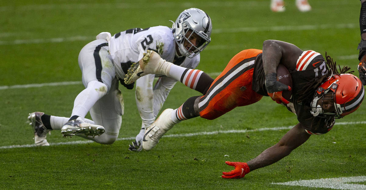 Las Vegas Raiders strong safety Johnathan Abram (24) tackles Cleveland Browns running back Kare ...