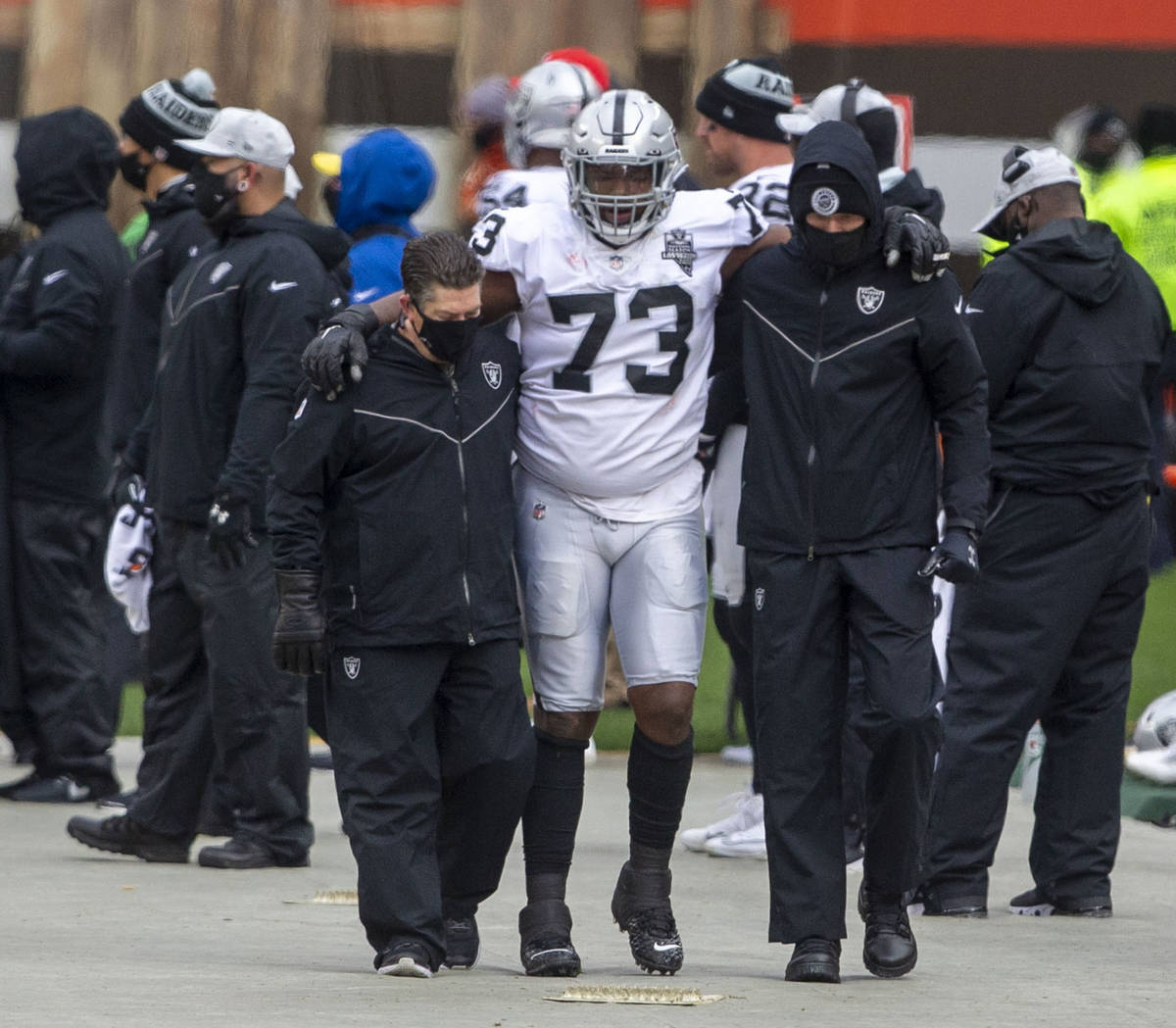 Las Vegas Raiders defensive tackle Maurice Hurst (73) is helped off the field following an inju ...