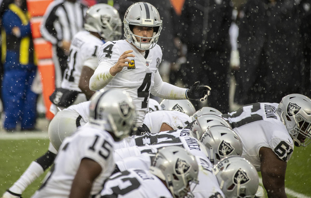 Las Vegas Raiders quarterback Derek Carr (4) calls an audible in the snow in the second quarter ...