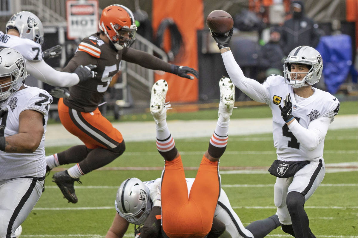 Las Vegas Raiders quarterback Derek Carr (4) makes a throw around pressure from Cleveland Brown ...