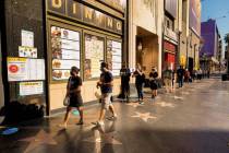 People wait in line to vote in-person outside the Hollywood Pantages Theatre, an official Los A ...