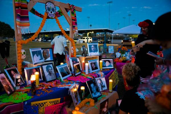 Volunteers set up an ofrenda at a Día de los Muertos event to honor people killed by polic ...
