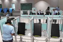 Clark County election workers set up voting booths at the Cora Coleman Senior Center in Las Veg ...