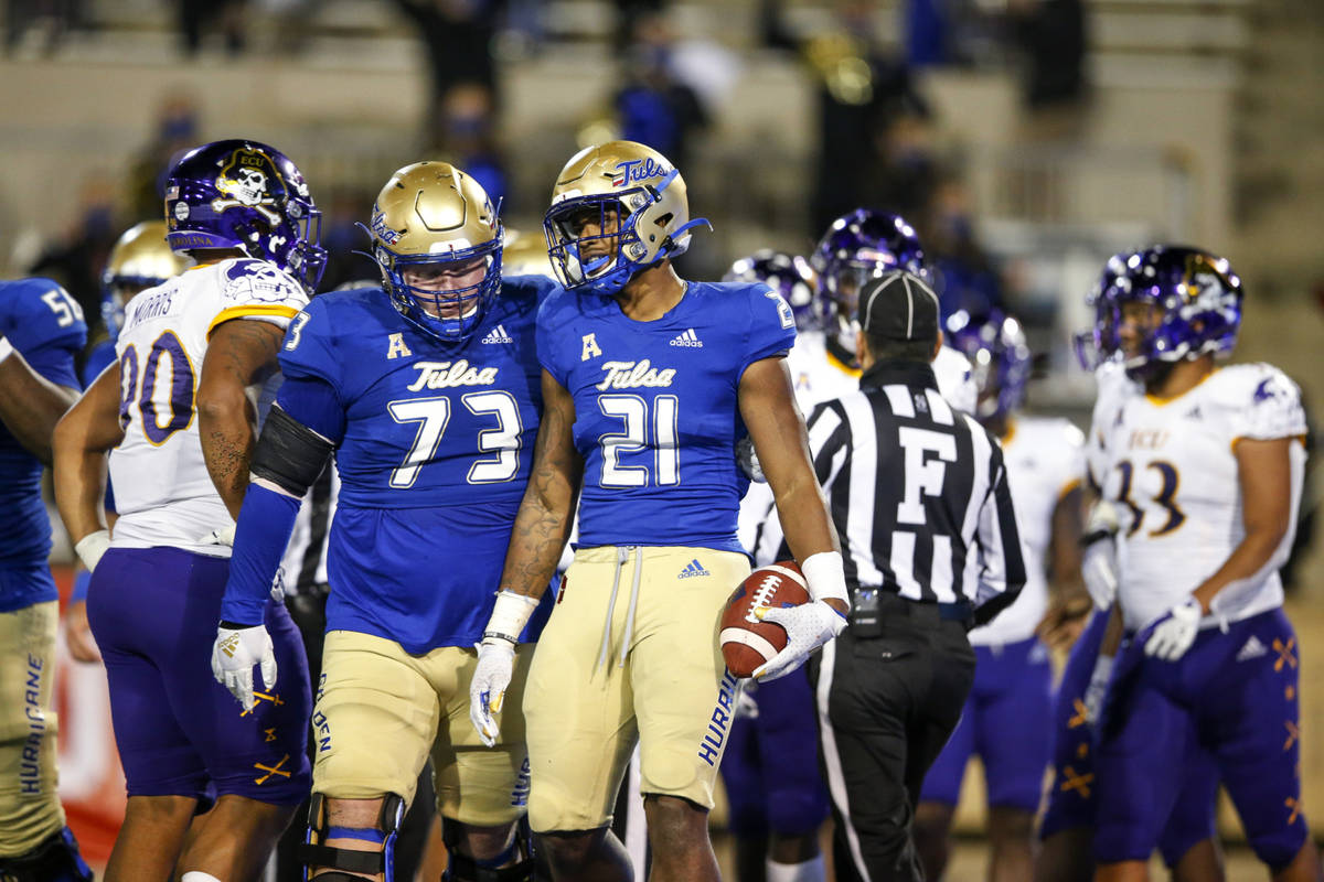 Tulsa offensive lineman Dylan Couch (73) congratulates running back TK Wilkerson (21) after Wil ...