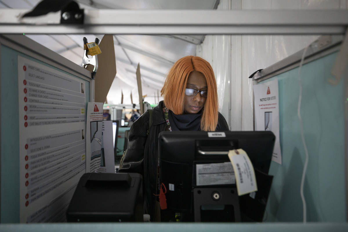 Hollany McKinnis, 41, of Henderson, casts her ballot at the Boulevard Mall polling station mi ...