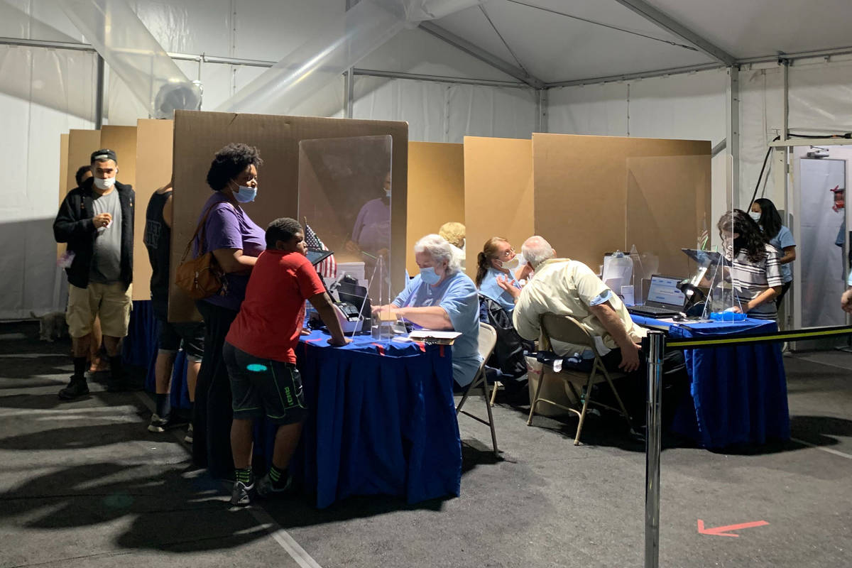 People cast their vote at the polling location in the Boulevard Mall parking lot in Las Vegas, ...