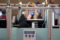 Jennifer McKay of Las Vegas votes at 7:35 a.m. surrounded by empty voting machines at Desert Br ...