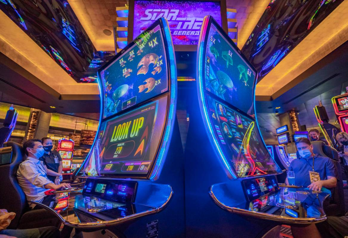 Individuals play Aristocrat Technologies' new Star Trek: The Next Generation Slot Game during t ...