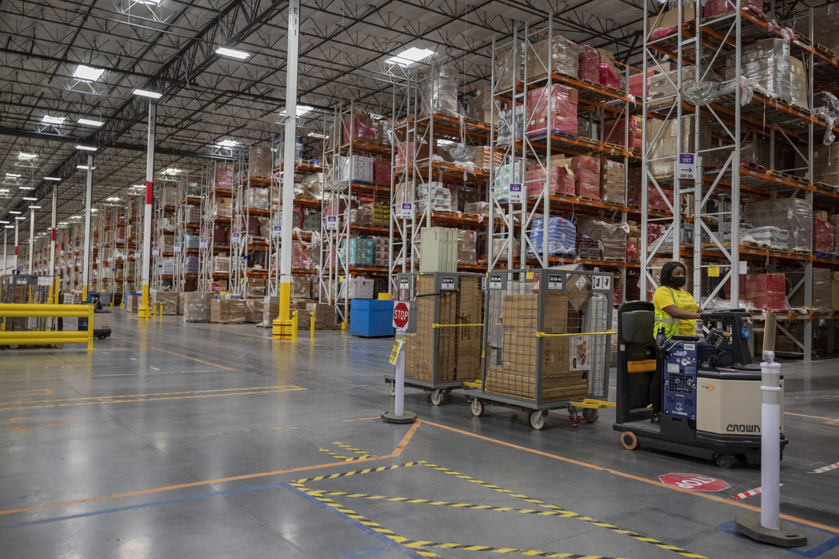 A worker is seen at an Amazon warehouse in North Las Vegas on Thursday, July 30, 2020. (Elizabe ...