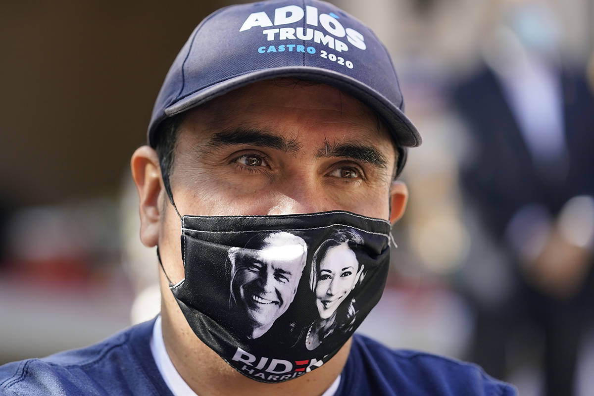 Andres Lopez listens to Democratic U.S. Senate candidate MJ Hegar during a campaign stop, Monda ...