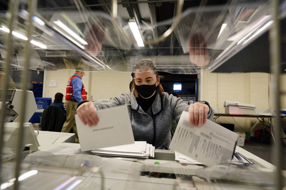 Chester County, Pa., election worker Kristina Sladek opens mail-in and absentee ballots for the ...