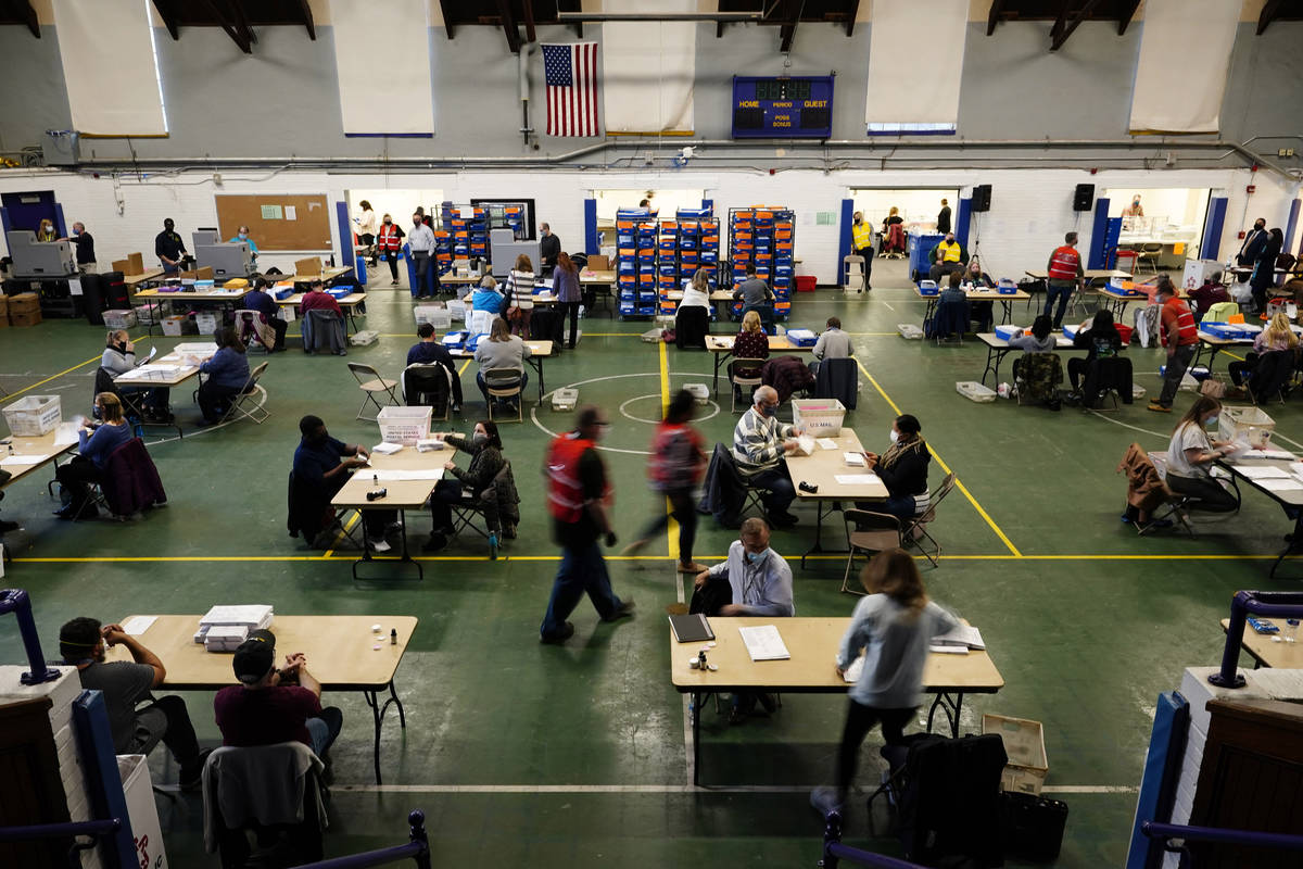 Chester County, Pa., election workers check mail-in and absentee ballots for the 2020 General E ...