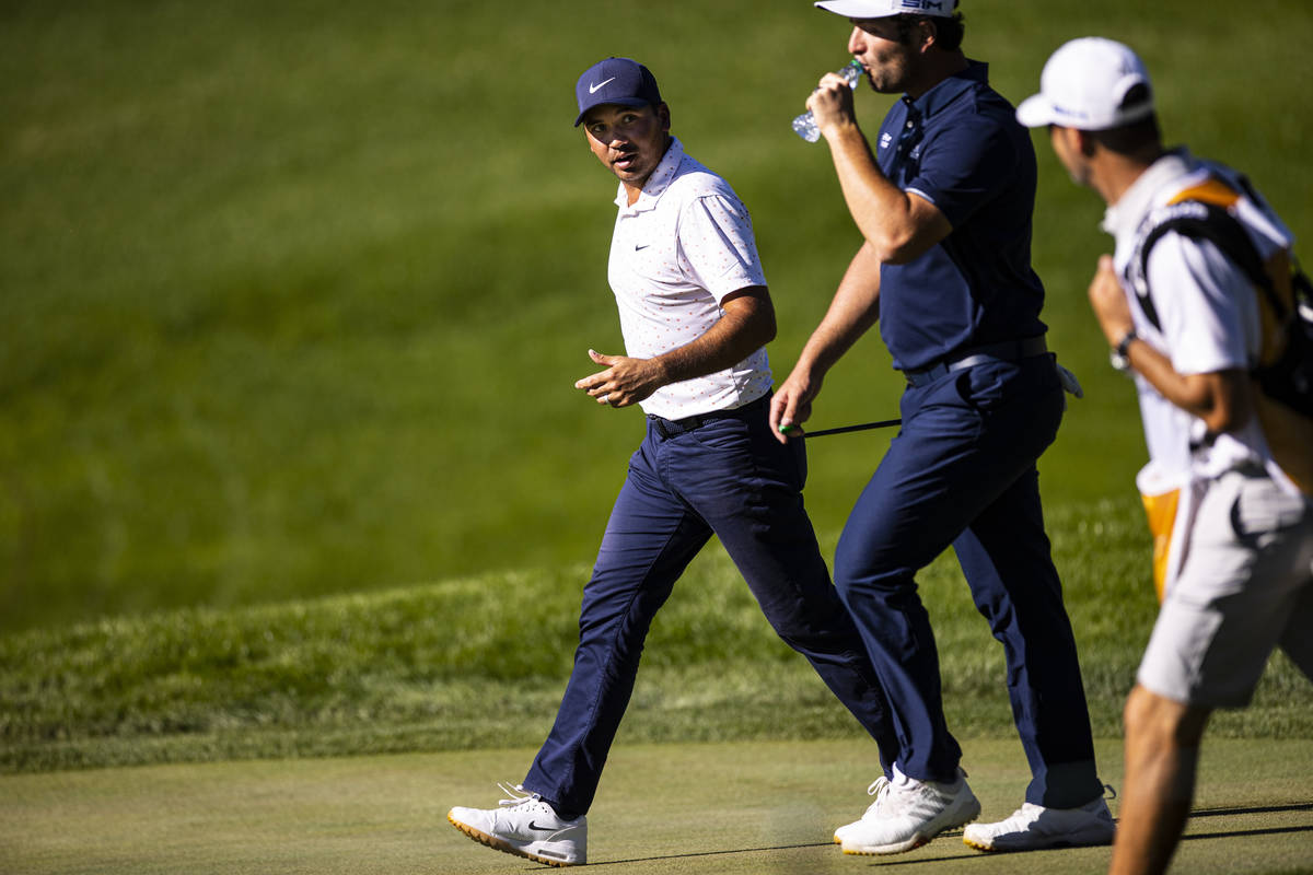Jason Day, left, talks with Jon Rahm as they walk toward the 13th green during the third round ...