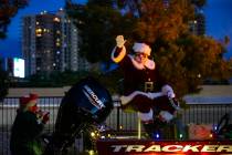 Santa Claus waves to people during a parade at Bass Pro Shops in Las Vegas on Saturday, Nov. 7, ...