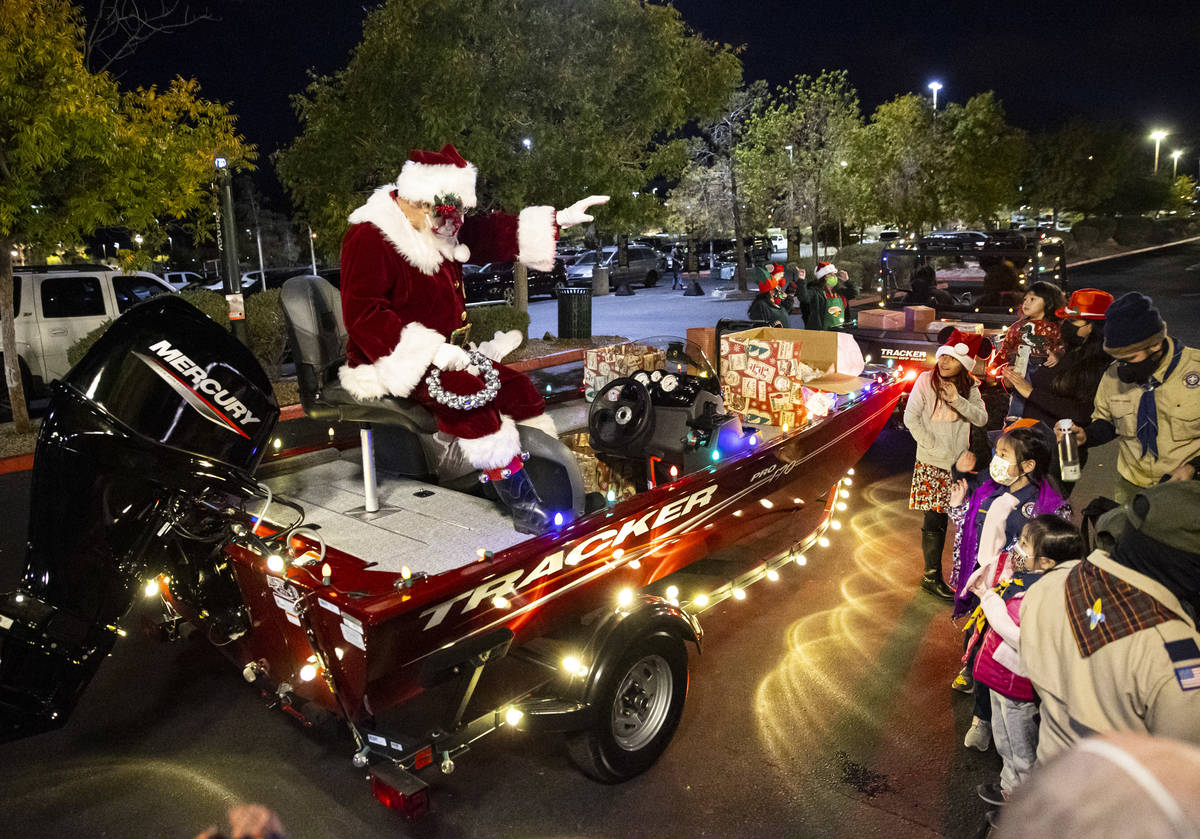 Santa Claus greets people and hands out toys during a parade at Bass Pro Shops in Las Vegas on ...