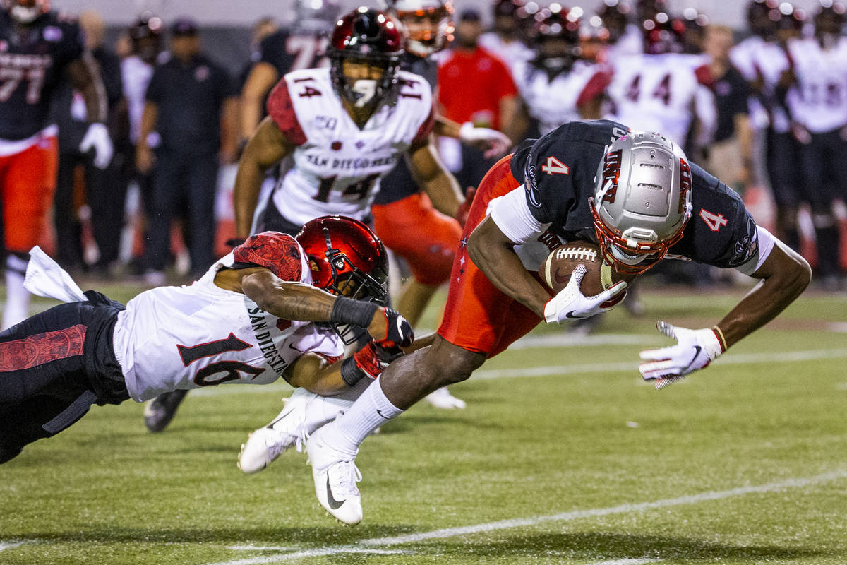 San Diego State Aztecs cornerback Luq Barcoo (16, left) is able to trip up UNLV Rebels wide rec ...