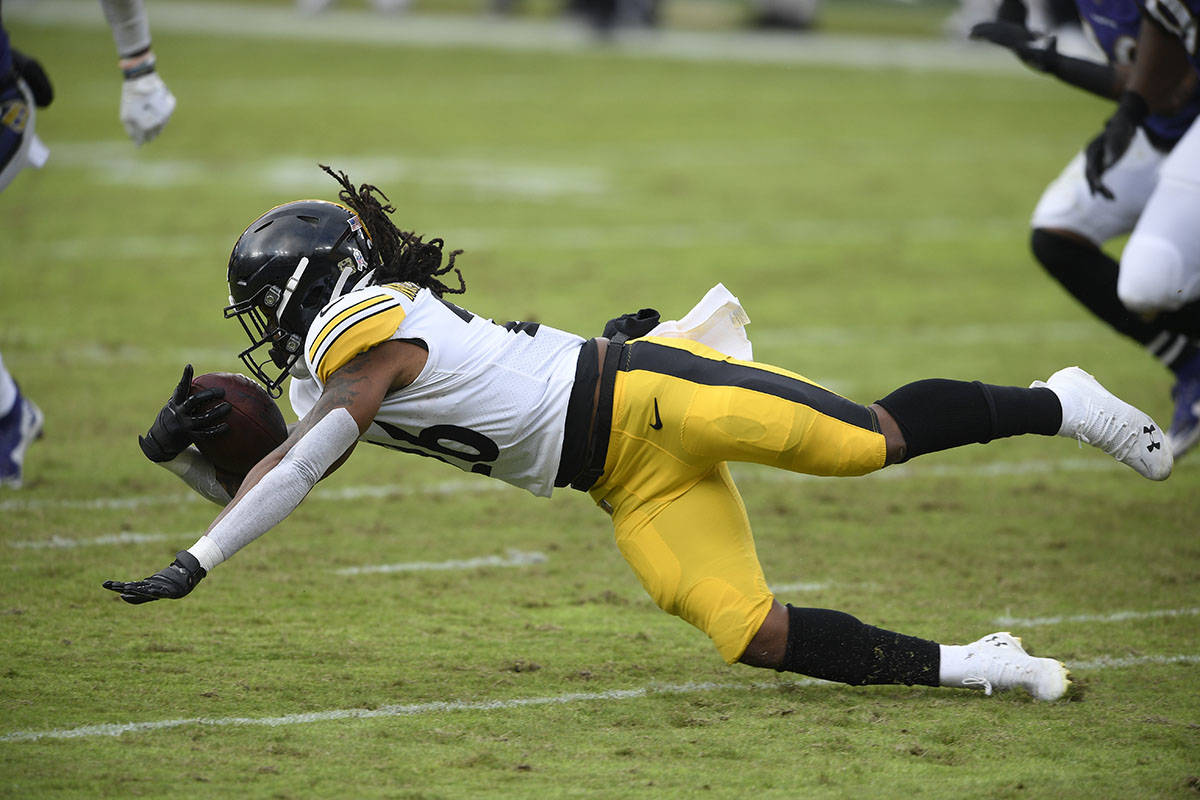 Pittsburgh Steelers running back Anthony McFarland (26) dives for yardage during the second hal ...