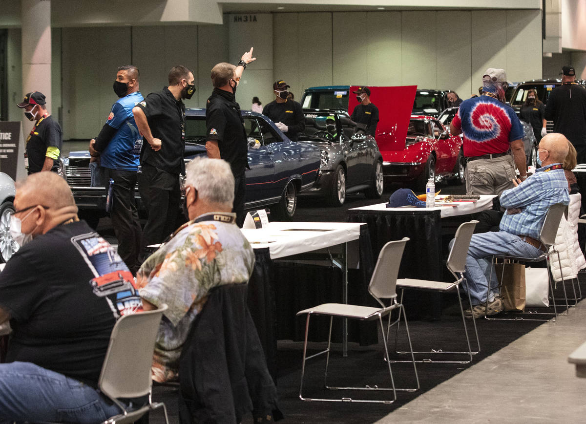 Bidders watch as classic cars are displayed to be auctioned at the Las Vegas Convention Center ...