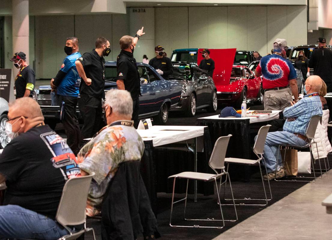 Bidders watch as classic cars are displayed to be auctioned at the Las Vegas Convention Center ...