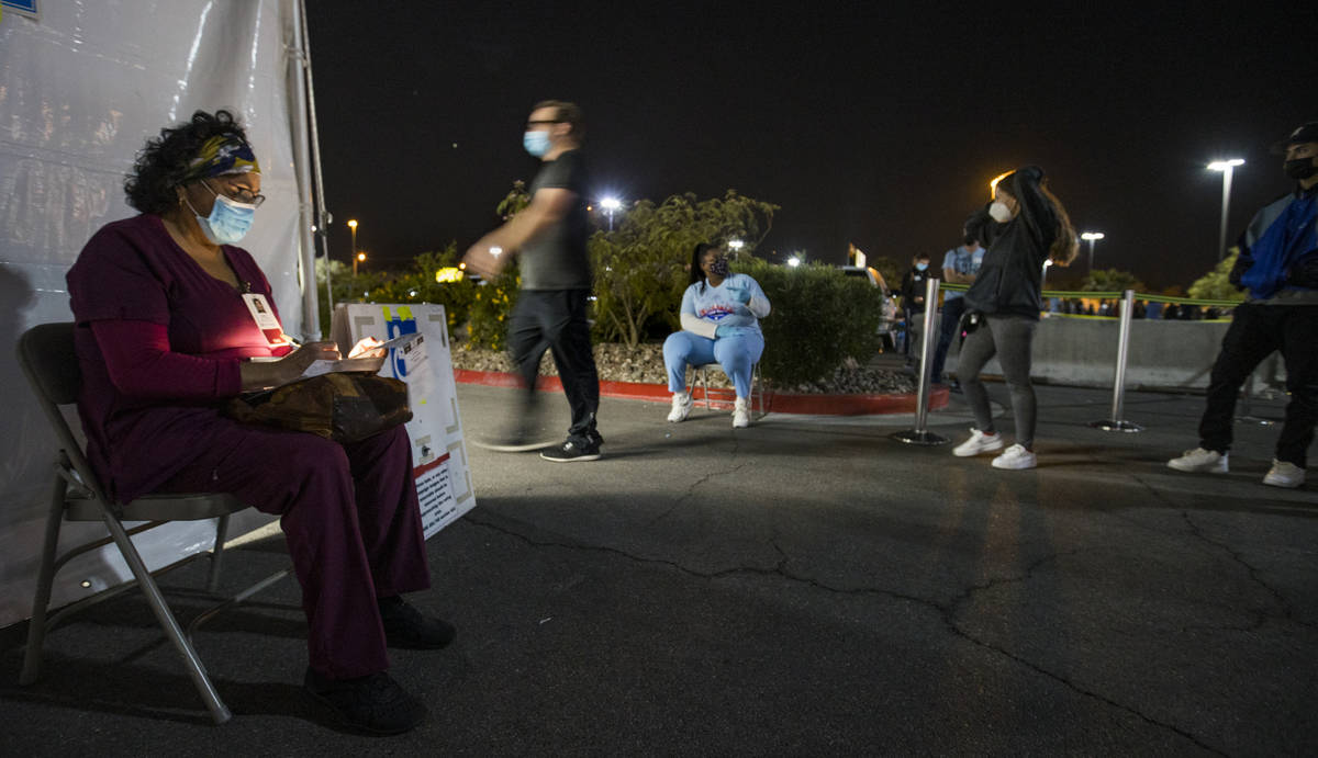 Raquel Carbajal sits outside as the voter line is still long late at the LVAC Rainbow voter cen ...