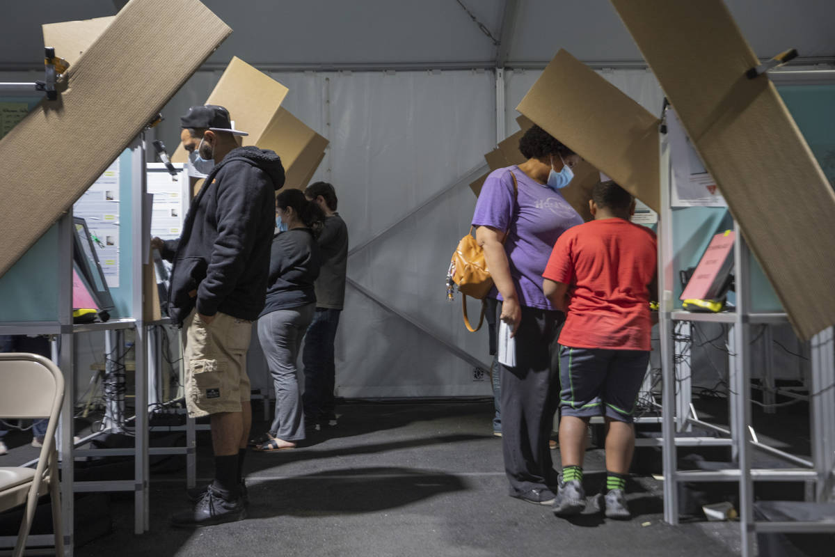 Individuals cast their ballots at the Boulevard Mall polling station during the last hour of vo ...