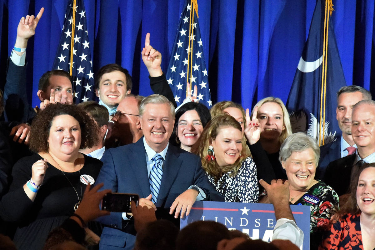 Supporters pose with U.S. Sen. Lindsey Graham, center, following his victory speech after winni ...
