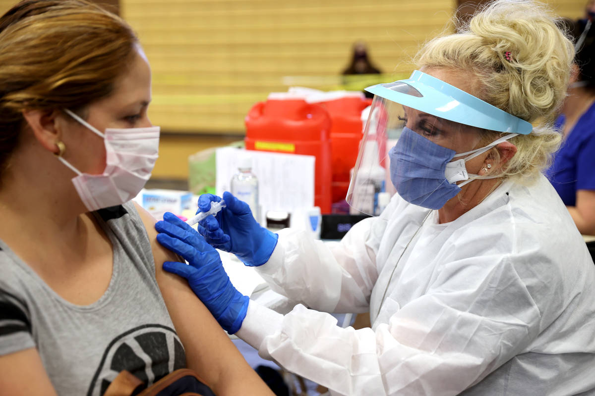 Maria Perez of North Las Vegas gets a flu vaccine from Lynda McCloskey during a Southern Nevada ...