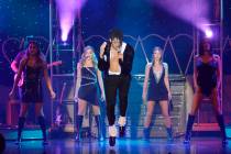 Jalles Franca, center, performs as Michael Jackson during "MJ Live" in the showroom at the Stra ...
