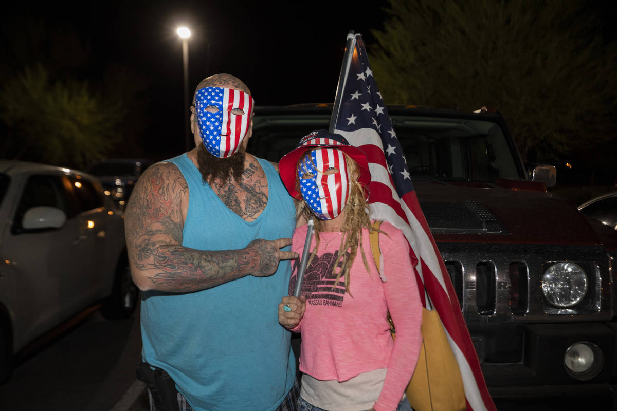 Mike Houlihan, 55, left, and Wetonia Houlihan, 48, of Henderson leave a Stop the Steal protest ...