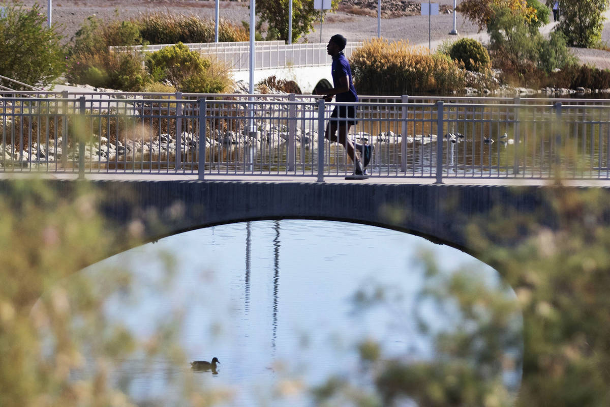 A man is jogging on pedestrian bridge at Cornerstone Park, on Thursday, Nov. 5, 2020, in Hender ...