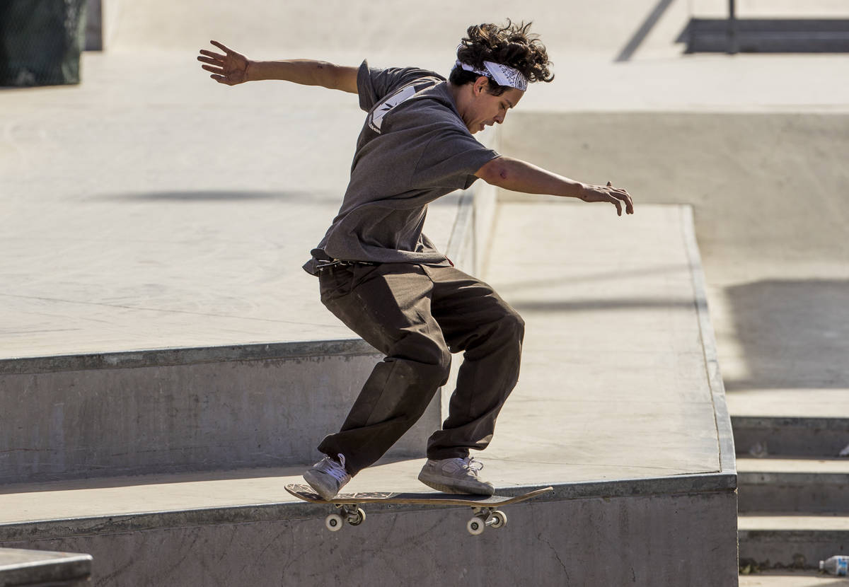 Skateboarder P.J. Dellatan catches some air while completing a backside 360 maneuver at the Cra ...