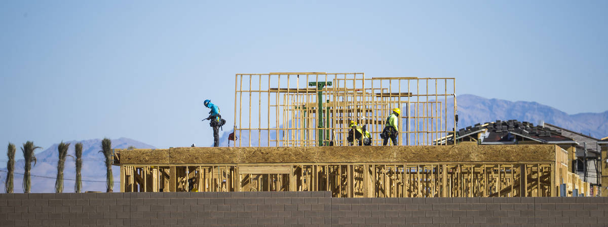 Construction workers continue some framing at the Watercolor development along Losee Road and E ...